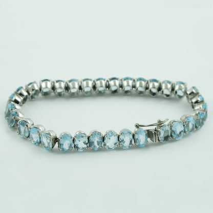 "Woven Drops" Silver Bracelet with Blue Topaz